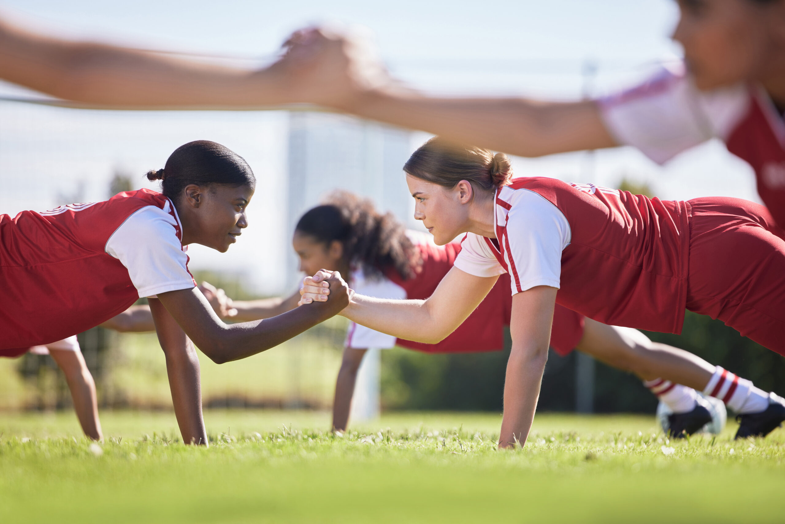 Women soccer, football or team sports holding hands in unity, support or motivation in routine work.